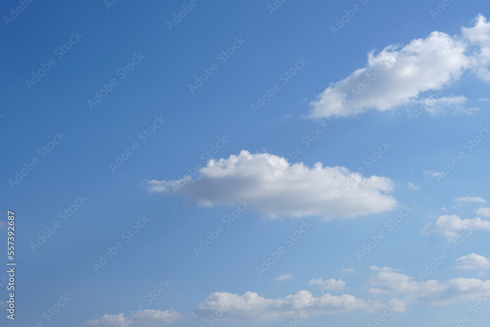 Blue sky with fluffy white clouds constantly changing shape.