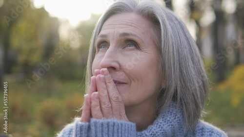 Wallpaper Mural Grateful senior woman raising eyes to sky asking god for blessing and healing Torontodigital.ca