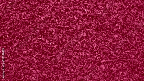 Viva Magenta abstract Food and Drink background. Color of the Year 2023. Dry Tea Wallpaper. Tea Leaves rotating on Turntable. Top View. Texture. Full Frame. Copy Space. Dried Tea is Spinning. photo