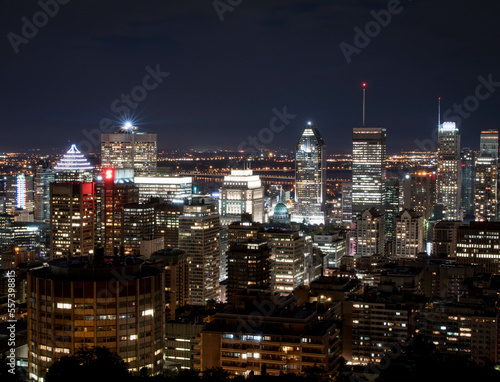 Montreal at night.Montreal panorama viewed from the Mount Royal.Night view of Montreal skyline with tall skyscrapers and busy street