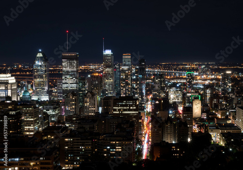 Montreal at night.Montreal panorama viewed from the Mount Royal.Night view of Montreal skyline with tall skyscrapers and busy street © TMC