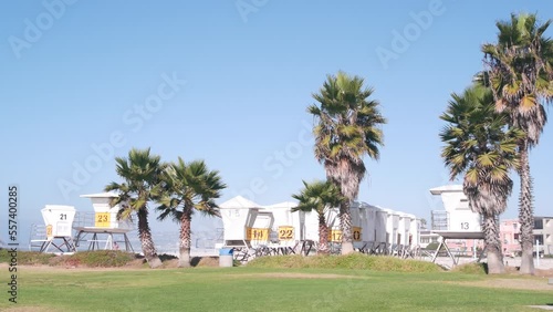 Lifeguard stand and palm tree, life guard tower for surfing on California beach. Summer pacific ocean in USA aesthetic. Iconic rescue baywatch station, coast lifesavers wachtower hut or house by sea.
