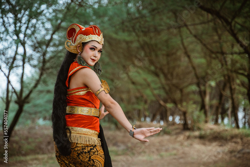 portrait young women presenting traditional Javanese dance movements photo