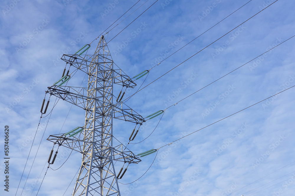 Electric power transmission against blue sky with light clouds, energy cooncept Electric power transmission against blue sky with light clouds, energy cooncept