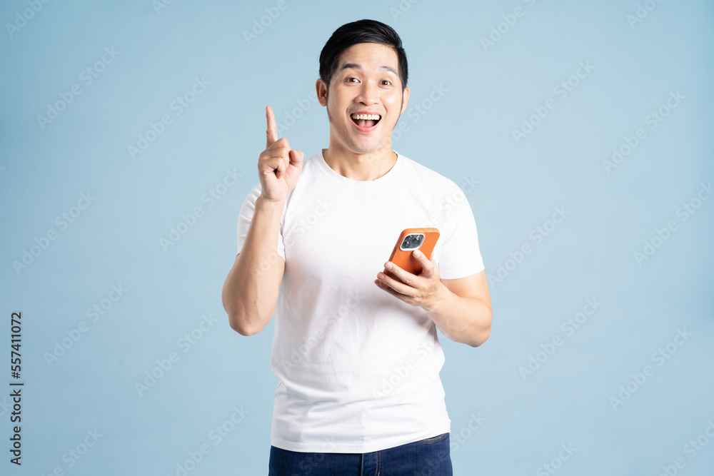 portrait of asian man posing on blue background portrait of asian man posing on blue background