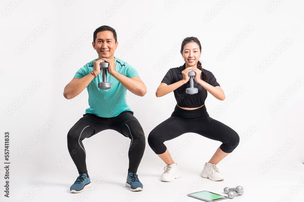man and woman squatting with one hand carrying dumbbells in front of chest on white background