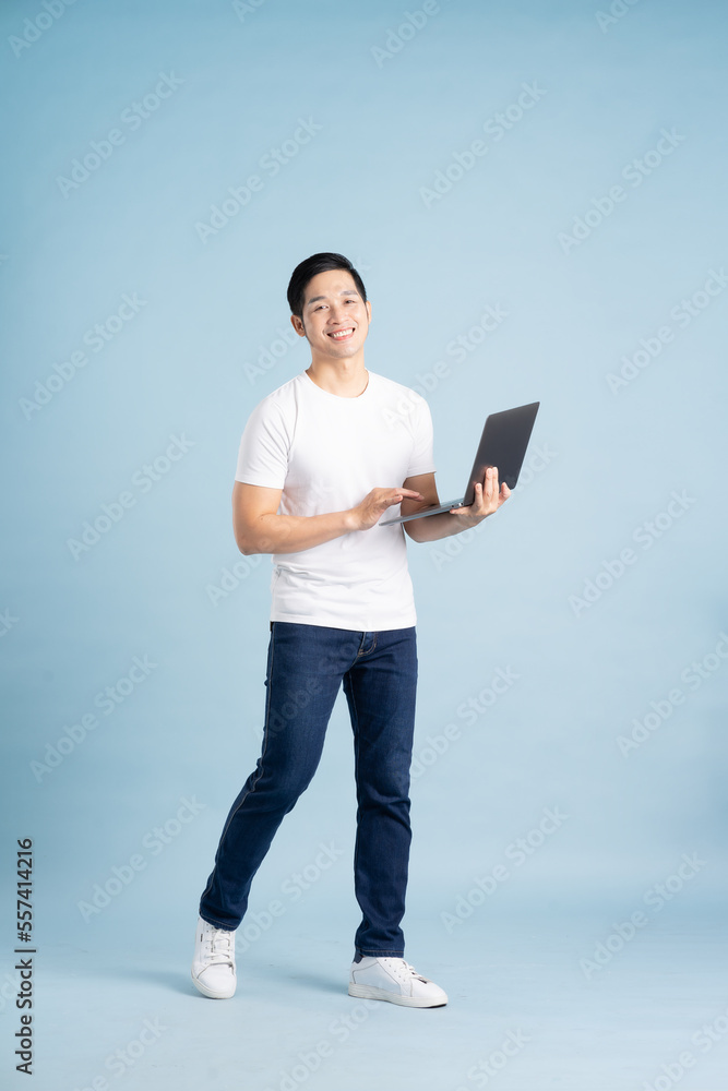 portrait of asian man posing on blue background