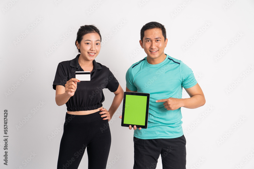 woman holding credit card and man showing camera tablet screen on isolated background woman holding credit card and man showing camera tablet screen on isolated background