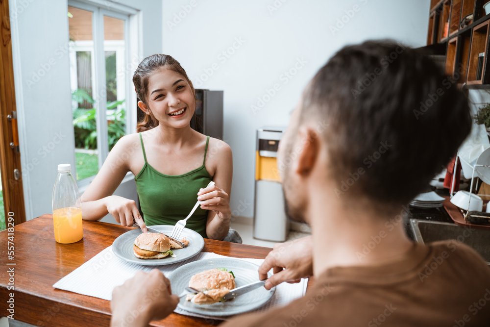 beautiful wife and husband having breakfast together at the dining table beautiful wife and husband having breakfast together at the dining table