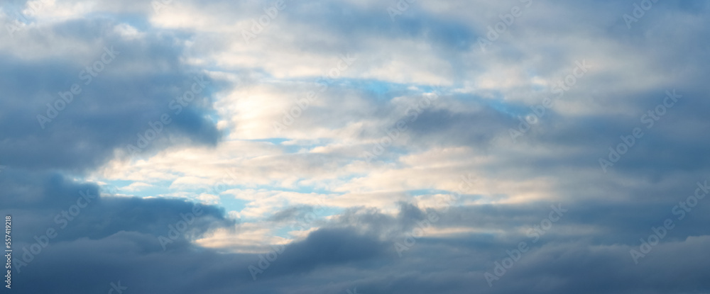 The sky with dark blue and light, illuminated by the evening sun, clouds