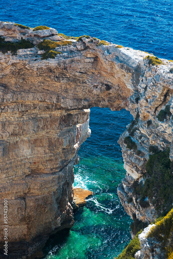Landward view from above of the famous Tripitos Arch, Paxos, Ionian Islands, Greece.  It is over 20 metres high, and has magnificently clear waters around its base