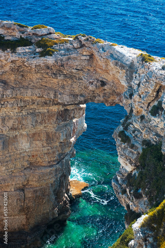 Landward view from above of the famous Tripitos Arch, Paxos, Ionian Islands, Greece. It is over 20 metres high, and has magnificently clear waters around its base