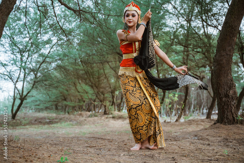 portrait young women presenting traditional Javanese dance movements photo