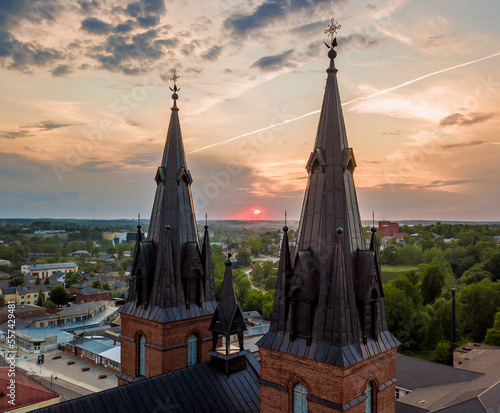 Aerial drone shot of sunset between Cathedral towers in Rezekne, Latvia photo