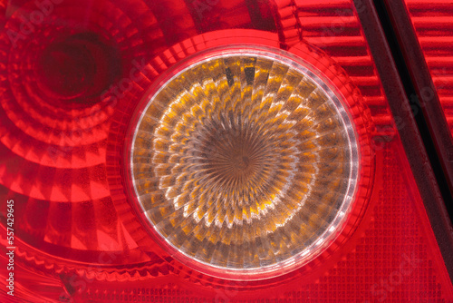 Red and orange translucent plastic abstract with circular and linear patterns
