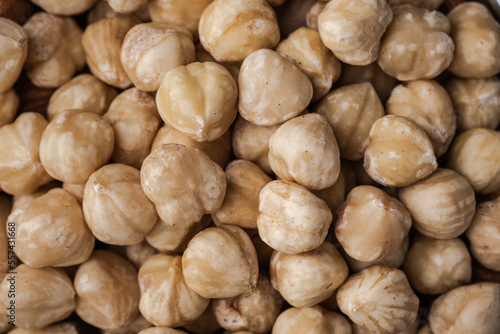 A pile of peeled hazelnuts as a textured background. Healthy nutrition concept