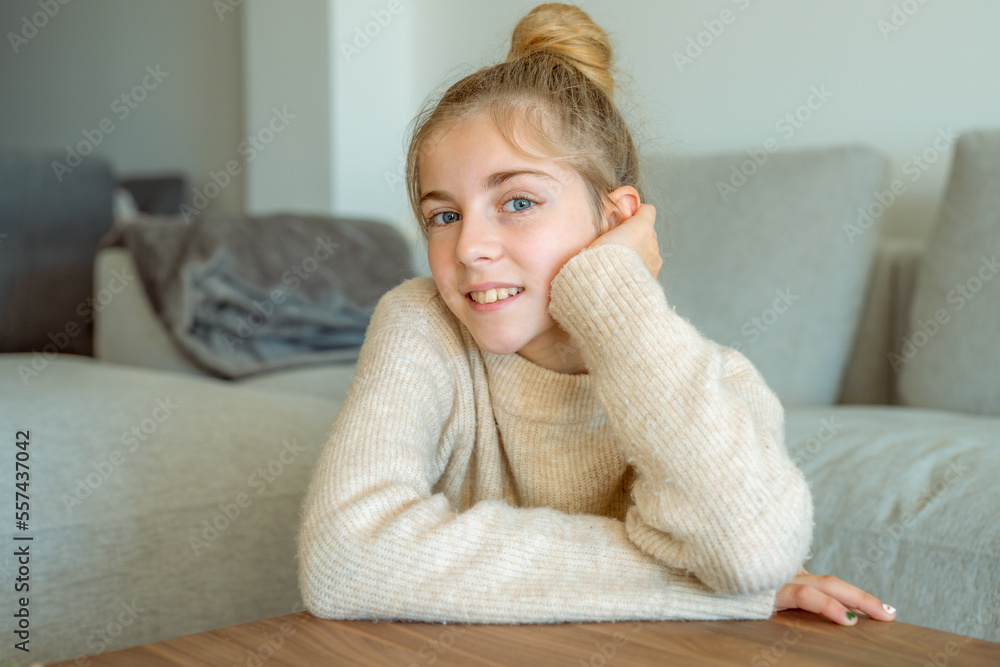 Smiling teen girl in casual cloths sitting on floor and relaxing at home Smiling teen girl in casual cloths sitting on floor and relaxing at home