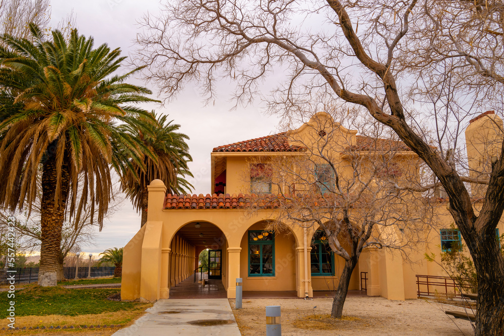 Fototapeta premium Mojave National Preserve Desert Wilderness Landscape Series at dusk, Old building and palm trees at Kelso Depot Visitor Center, in Kelso, California, USA