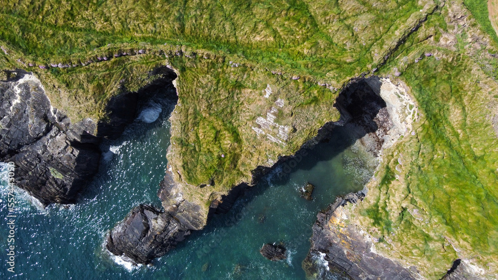 Grassy cliffs on the Atlantic Ocean coast. Landscape of Ireland from a height. Seaside rocks. Drone point of view. Grassy cliffs on the Atlantic Ocean coast. Landscape of Ireland from a height. Seaside rocks. Drone point of view.