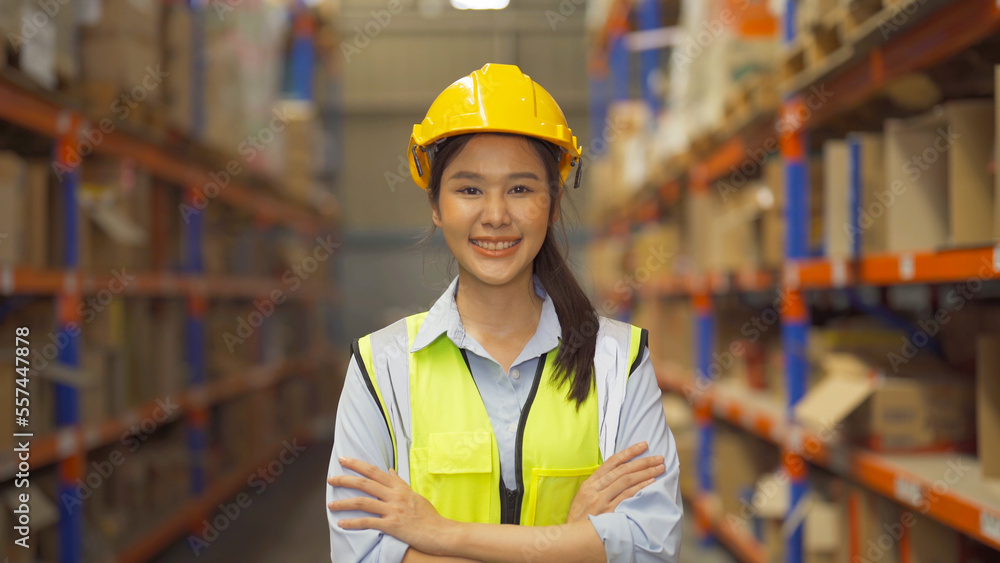 Portrait of Asian woman worker working in large warehouse retail store industry factory. Rack of stock storage. Cargo in ecommerce and logistic concept. Depot. People lifestyle. Shipment service. Portrait of Asian woman worker working in large warehouse retail store industry factory. Rack of stock storage. Cargo in ecommerce and logistic concept. Depot. People lifestyle. Shipment service.
