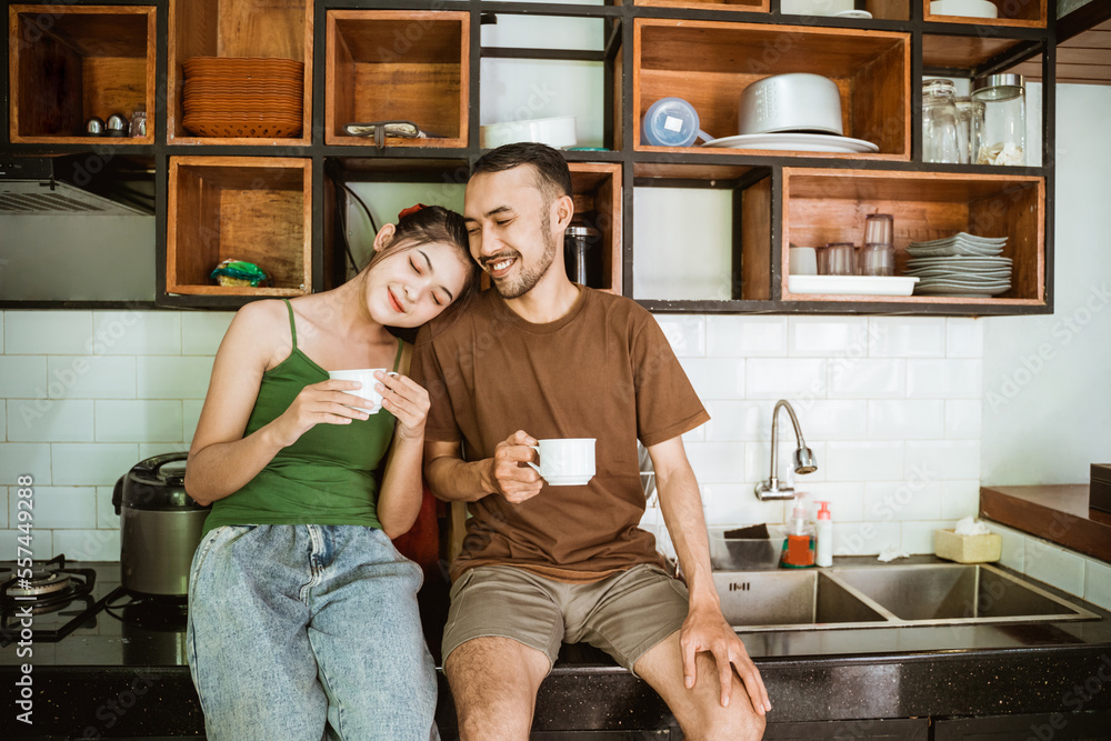 romantic woman and man drinking coffee using cups on kitchen background romantic woman and man drinking coffee using cups on kitchen background