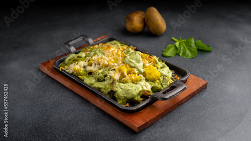 chicken spinach pasta baked in oven with cheese and mashed potato served in dish isolated on table top view of arabic food