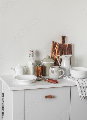 Scandinavian style kitchen interior. Dishes on a white cabinet. Cooking. Cozy kitchen