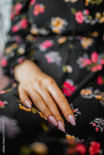 Vertical photo of girl hand with pink manicure