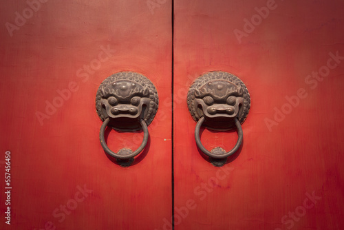 Chinese dragon door knockers on red doors