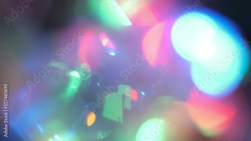 flashing light bulbs. Defocused neon green and blue color shiny flecks motion on dark black abstract background.