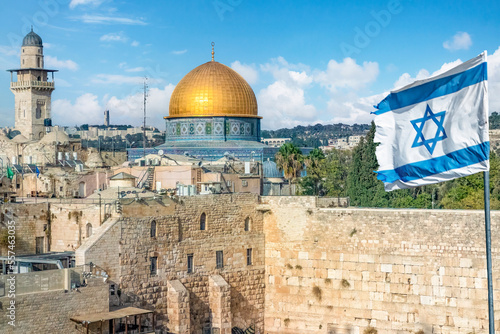 An Israeli flag blows by the Western Wall and dome of the rock in Old City in Jerusalem, Israel.	
