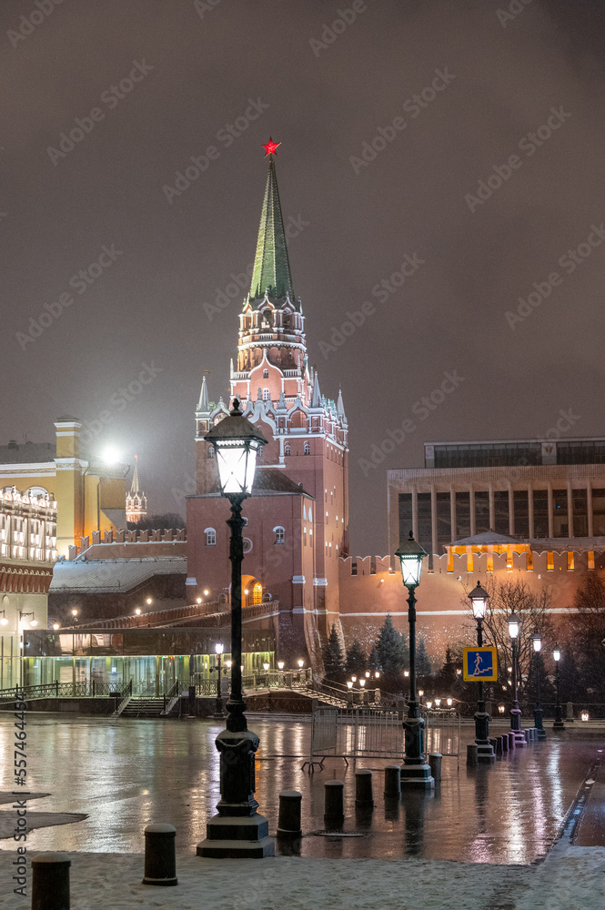 Moscow, Russia - December 27, 2022: Tower of the Moscow Kremlin. Cold and deserted Moscow street on a snowy winter evening near Red Square