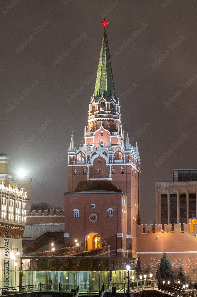 Moscow, Russia - December 27, 2022: Tower of the Moscow Kremlin. Cold and deserted Moscow street on a snowy winter evening near Red Square