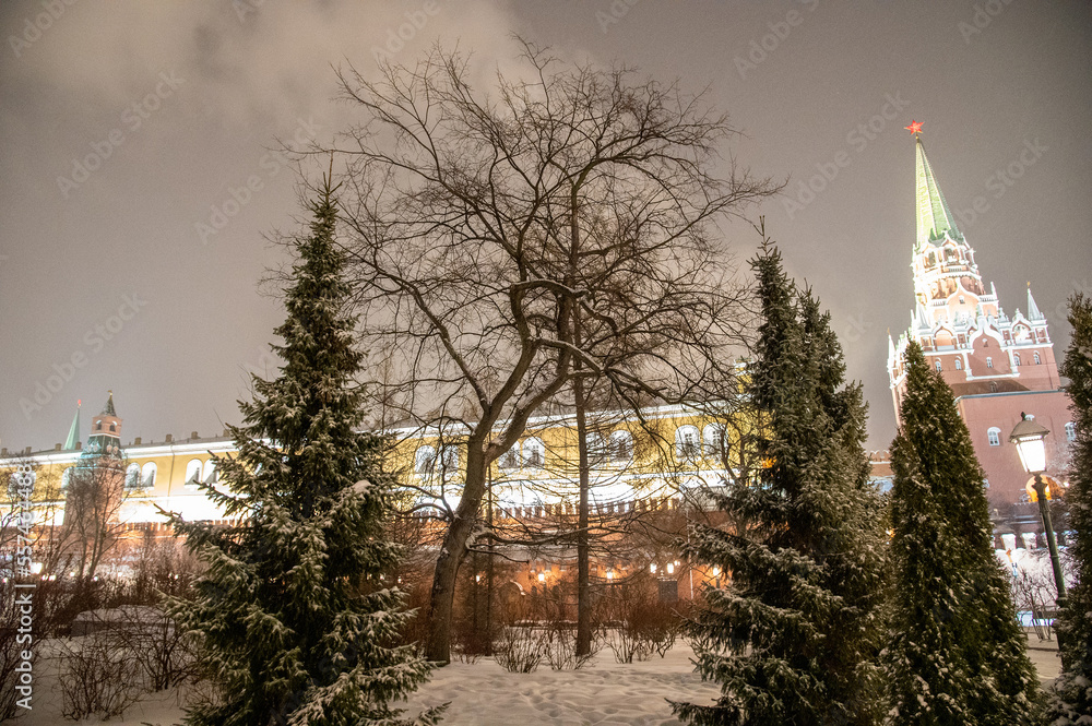 Moscow, Russia - December 27, 2022: Tower of the Moscow Kremlin. Cold and deserted Moscow street on a snowy winter evening near Red Square