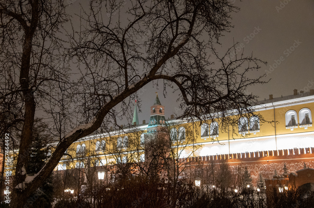Moscow, Russia - December 27, 2022: Tower of the Moscow Kremlin. Cold and deserted Moscow street on a snowy winter evening near Red Square