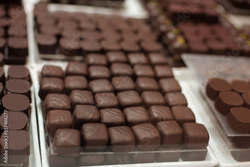 Delicious sweets and cookies made of black and brown chocolate on the festive table