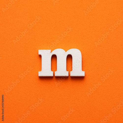 Obraz na płótnie m white lowercase letter - Background in orange foamy