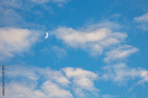 Moon on blue sky with clouds © Grzegorz