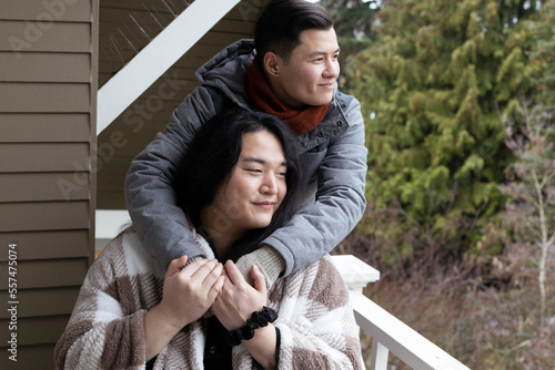Fotografie Asian American trans friends hugging.