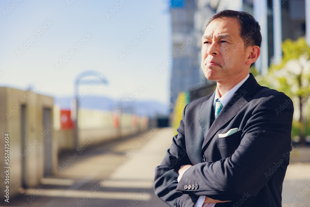 Middle-aged Asian man in black business suit at Kyoto station building, Japan. Middle-aged Asian man in black business suit at Kyoto station building, Japan.