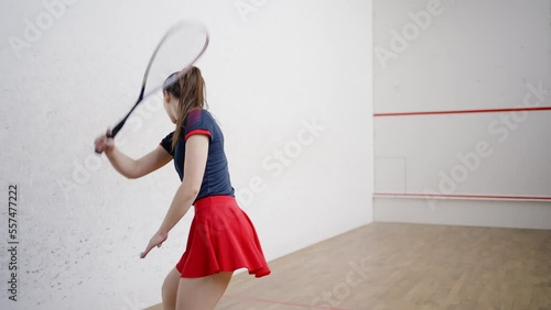 Sportive woman rests actively exercising on squash court photo