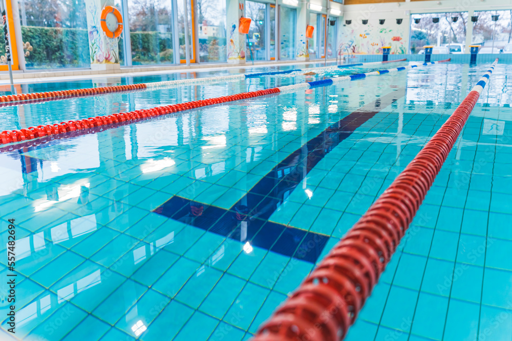Obraz premium Indoor public swimming pool lanes close-up to the water. No people swimming. High quality photo