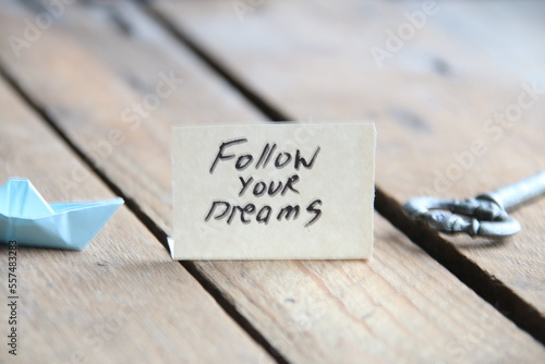 Follow your dreams text written on a tag.