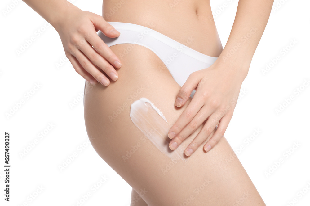 Woman with body cream smear on hip against white background, closeup