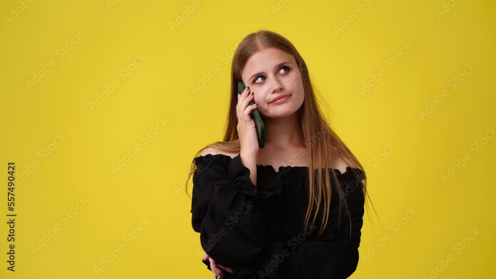 4k slow motion video of woman using her phone on yellow background. 4k slow motion video of woman using her phone on yellow background.