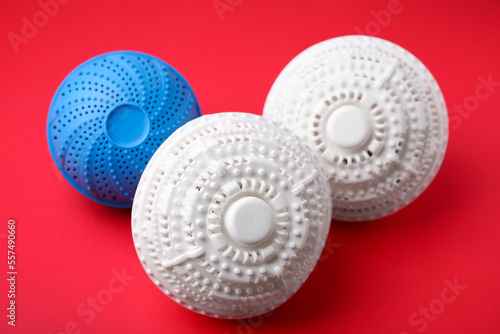 Dryer balls for washing machine on red background. Laundry detergent substitute