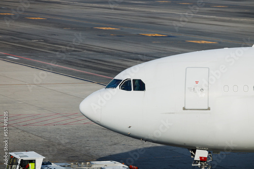 white Airplane nose close-up photography. Commercial aircraft at the airport