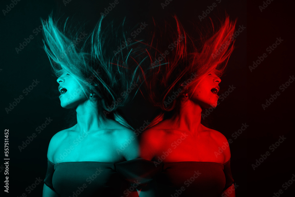 Fashion concept. Portrait of beautiful woman with flying hair in red and blue color split effect style. Futuristic looking style. Image contains motion blur. Model with happy facial expression Fashion concept. Portrait of beautiful woman with flying hair in red and blue color split effect style. Futuristic looking style. Image contains motion blur. Model with happy facial expression