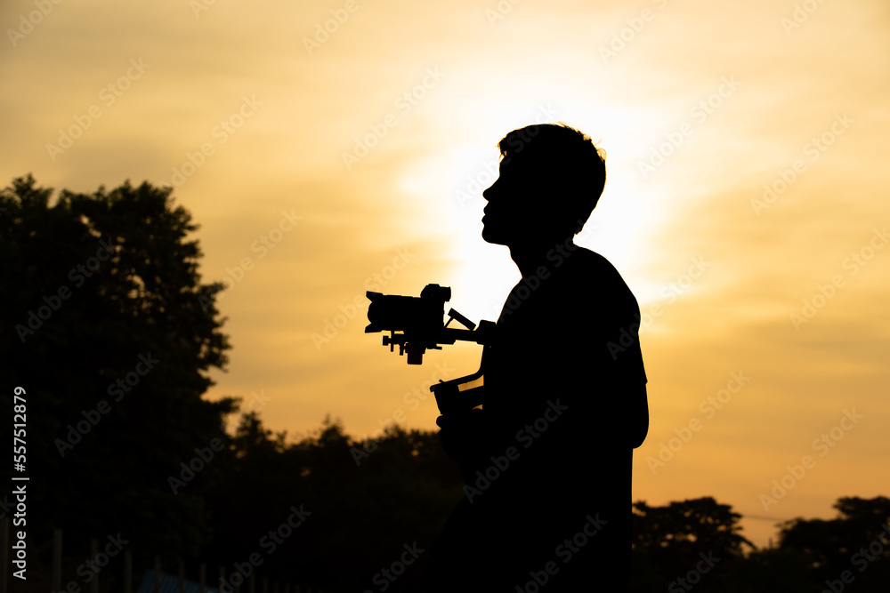 photo of Cameraman silhouette at sunset
