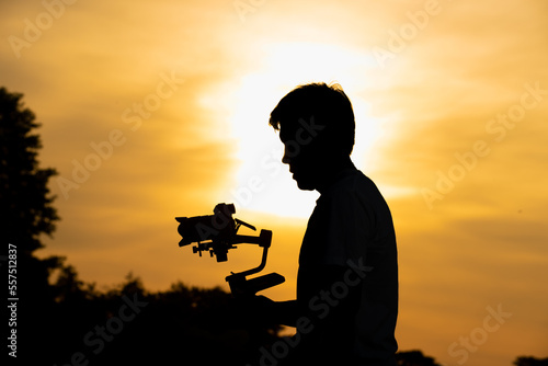 Videographer's shadow behind at sunset